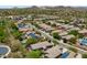 An aerial shot shows a desert community with homes, mountain views, and solar panels on many of the roofs at 12727 W Lowden Rd, Peoria, AZ 85383