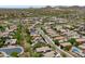 An aerial photo of desert community homes, mountains, and solar panels on many roofs for energy efficiency at 12727 W Lowden Rd, Peoria, AZ 85383