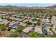 An aerial view features desert community homes and mountain views, some houses with pools and solar panels at 12727 W Lowden Rd, Peoria, AZ 85383