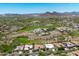 Expansive aerial view showcasing luxury homes alongside a golf course, set against a mountain backdrop at 12727 W Lowden Rd, Peoria, AZ 85383
