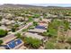 A scenic aerial view of a community with well-maintained homes, natural desert landscaping, and mountain vistas at 12727 W Lowden Rd, Peoria, AZ 85383