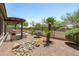 This expansive backyard boasts a covered patio, grill, and pristine desert landscaping at 12727 W Lowden Rd, Peoria, AZ 85383