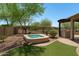 This relaxing backyard features a cozy spa, an outdoor kitchen and pristine landscaping at 12727 W Lowden Rd, Peoria, AZ 85383