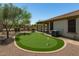 An incredible backyard putting green with desert landscaping and patio at 12727 W Lowden Rd, Peoria, AZ 85383