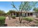 A spacious backyard featuring desert landscaping, a patio, and lush artificial turf at 12727 W Lowden Rd, Peoria, AZ 85383