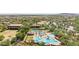 Overhead shot of a stunning community pool area with multiple pools and lounge spaces amid lush landscaping at 12727 W Lowden Rd, Peoria, AZ 85383