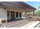 Covered patio with a barbecue area, ceiling fan, and a beautiful view of the backyard and desert landscaping at 12727 W Lowden Rd, Peoria, AZ 85383