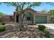 Inviting single-story home with desert landscaping, complemented by a green garage door and matching window shutters at 12727 W Lowden Rd, Peoria, AZ 85383