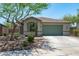 Charming single-story home featuring a low-maintenance yard, a two-car garage and attractive desert landscaping at 12727 W Lowden Rd, Peoria, AZ 85383