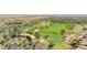 Picturesque aerial view of a meticulously manicured golf course with water features, surrounded by homes and natural desert at 12727 W Lowden Rd, Peoria, AZ 85383