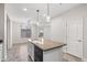 Kitchen island with sink, dishwasher, and granite countertop with decorative hanging lights above at 12727 W Lowden Rd, Peoria, AZ 85383