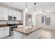 Bright kitchen with white cabinets, stainless steel appliances and an island with sink and granite countertops at 12727 W Lowden Rd, Peoria, AZ 85383