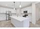 Kitchen features island with pendant lighting, stainless appliances, and white cabinetry at 12727 W Lowden Rd, Peoria, AZ 85383
