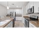 Kitchen with stainless appliances, white cabinets, granite countertops, and tile floors at 12727 W Lowden Rd, Peoria, AZ 85383