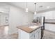 Spacious kitchen island, stainless appliances, white cabinets and granite countertops at 12727 W Lowden Rd, Peoria, AZ 85383