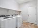 Laundry room equipped with a washer, dryer, and shelving for storage at 12727 W Lowden Rd, Peoria, AZ 85383