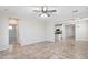 Open concept living area with tile flooring, neutral paint, and view into kitchen at 12727 W Lowden Rd, Peoria, AZ 85383