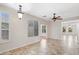Spacious living room bathed in natural light, adorned with ceramic tile flooring and a classic ceiling fan at 12727 W Lowden Rd, Peoria, AZ 85383