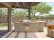 Outdoor cooking area featuring a built-in grill and countertop space with a view of the backyard at 12727 W Lowden Rd, Peoria, AZ 85383