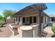 Backyard patio with built-in grill, countertops and pergola providing shade for entertaining or relaxing at 12727 W Lowden Rd, Peoria, AZ 85383