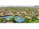 Aerial perspective of pristine tennis courts surrounded by mature trees and well-kept grounds in a residential area at 12727 W Lowden Rd, Peoria, AZ 85383