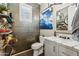 A stylish bathroom featuring modern fixtures, marble countertops, grey cabinetry, and textured tile at 13088 N 91St Dr, Peoria, AZ 85381