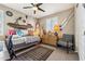 Nautical-themed bedroom features a cozy daybed, decorative oars, a surfboard, and unique decor at 13088 N 91St Dr, Peoria, AZ 85381