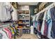 Organized walk-in closet featuring ample shelving, hanging space, and storage solutions at 13088 N 91St Dr, Peoria, AZ 85381