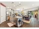 An open kitchen with grey cabinets, granite countertops, stainless steel appliances and a view of the dining area at 13088 N 91St Dr, Peoria, AZ 85381