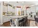 An open kitchen with grey cabinets, granite countertops, an island and stainless steel appliances at 13088 N 91St Dr, Peoria, AZ 85381