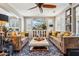 Spacious living room with plush sofas, shuttered windows, and stylish decor for a comfortable and elegant ambiance at 13088 N 91St Dr, Peoria, AZ 85381