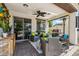Inviting covered patio with comfortable seating, ceiling fan, and outdoor kitchen setup, perfect for entertaining at 13088 N 91St Dr, Peoria, AZ 85381