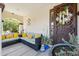 Charming front porch with a comfortable seating area and an inviting entrance at 13088 N 91St Dr, Peoria, AZ 85381
