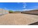 Large, undeveloped backyard space with block fencing and views of the surrounding desert landscape at 13294 W Eagle Feather Rd, Peoria, AZ 85383