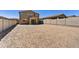 Spacious backyard showing the home's exterior and block fencing, ready for landscaping at 13294 W Eagle Feather Rd, Peoria, AZ 85383