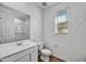 Bright bathroom featuring a white vanity, toilet, mirror, and hard surface flooring at 13294 W Eagle Feather Rd, Peoria, AZ 85383