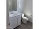 A clean, simple bathroom with wood-look flooring, a vanity, and a toilet at 13294 W Eagle Feather Rd, Peoria, AZ 85383