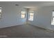 Bright bedroom with neutral carpet, paint, and several windows that brings in natural light at 13294 W Eagle Feather Rd, Peoria, AZ 85383