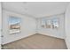 Bright bedroom featuring carpet floors, white walls, and three large windows at 13294 W Eagle Feather Rd, Peoria, AZ 85383