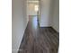Hallway featuring stylish wood-look tile flooring and neutral paint that creates a clean aesthetic at 13294 W Eagle Feather Rd, Peoria, AZ 85383