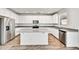 Bright kitchen featuring white cabinets, granite countertops, stainless steel appliances, and an island at 13294 W Eagle Feather Rd, Peoria, AZ 85383