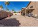 Backyard boasts a covered patio, comfortable seating, desert landscaping, and a vibrant blue sky at 13750 W Roanoke Ave, Goodyear, AZ 85395