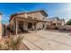 Expansive backyard featuring a covered patio, comfortable seating, and a low-maintenance landscape at 13750 W Roanoke Ave, Goodyear, AZ 85395