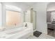 Bright bathroom featuring a soaking tub beneath a window and a separate shower at 13750 W Roanoke Ave, Goodyear, AZ 85395