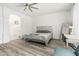 Inviting bedroom with a relaxing atmosphere, complemented by natural light and wood-look floors at 13750 W Roanoke Ave, Goodyear, AZ 85395