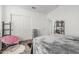 Bright bedroom showcasing a decorative bed, closet, shelving and plenty of natural light at 13750 W Roanoke Ave, Goodyear, AZ 85395