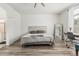 Well-lit bedroom showcasing neutral decor, wood-look floors, and a peaceful ambiance at 13750 W Roanoke Ave, Goodyear, AZ 85395