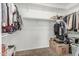 Spacious walk-in closet with ample hanging space, shelving and room for storage boxes at 13750 W Roanoke Ave, Goodyear, AZ 85395