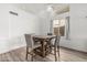 Cozy dining area with wood-look floors, a modern light fixture, white walls, and table seating for four at 13750 W Roanoke Ave, Goodyear, AZ 85395