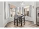 Cozy dining area bathed in natural light, featuring a modern chandelier and scenic views at 13750 W Roanoke Ave, Goodyear, AZ 85395